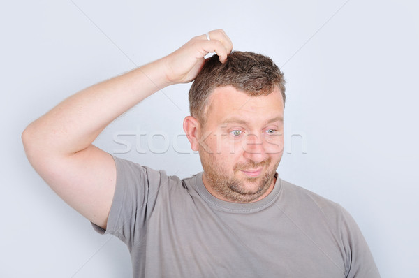 Young man with confused expression on face Stock photo © zurijeta