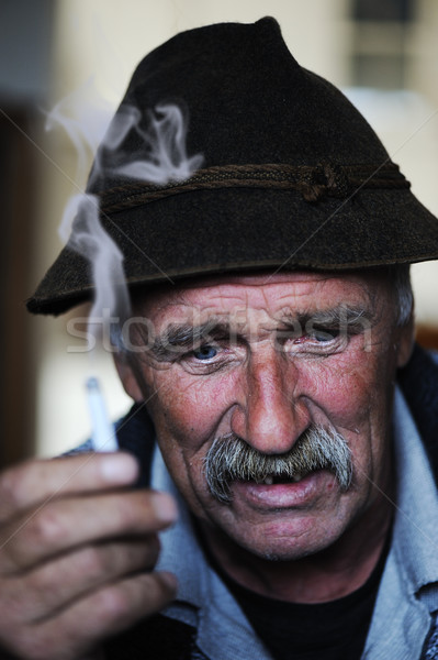 Closeup Artistic Photo of Aged Man With  Grey Mustache Smoking Cigarette  Stock photo © zurijeta