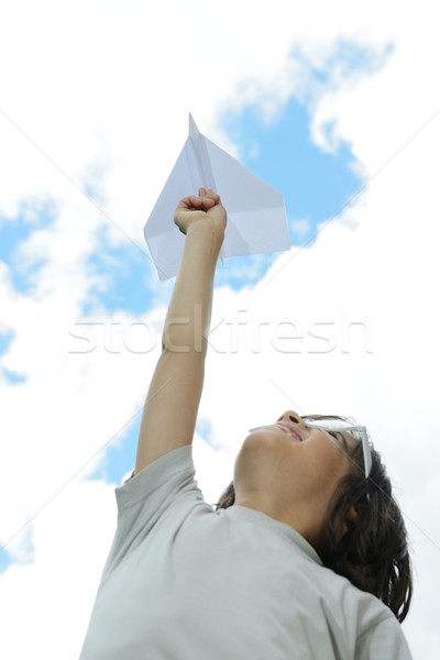 Kid flying a paper airplane Stock photo © zurijeta