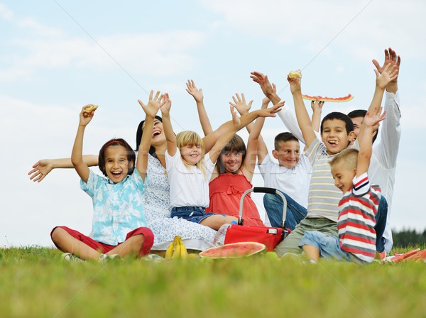 Family with children having picnic time on green meadow in natur Stock photo © zurijeta
