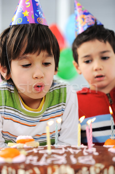 Two little boys blowing candles on cake, happy birthday party Stock photo © zurijeta