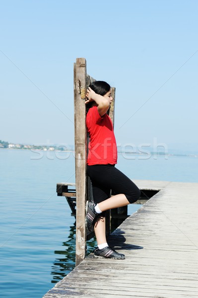 Lány dokk gyönyörű tó tenger víz Stock fotó © zurijeta
