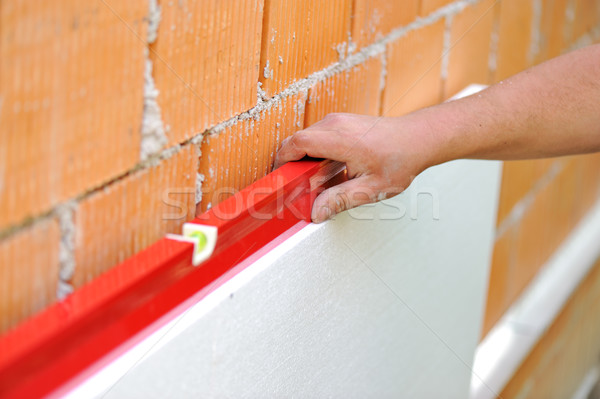 Worker checking horizontal level with leveling tool Stock photo © zurijeta
