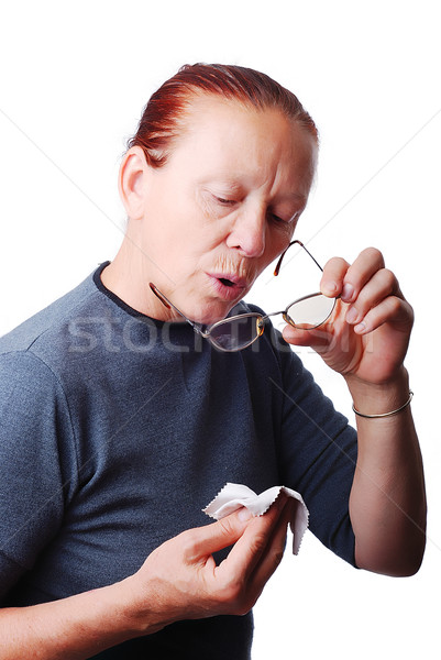 Elderly woman cleaning her glasses Stock photo © zurijeta
