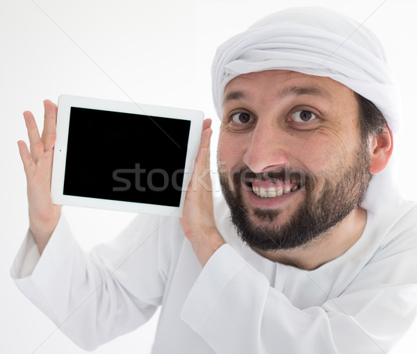 Arabic man wearing traditional clothes holding tablet for messag Stock photo © zurijeta