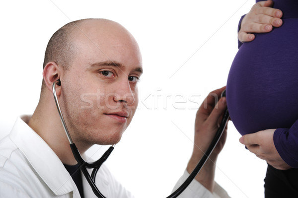 Doctor concentrating on pregnancy examination with stethoscope Stock photo © zurijeta