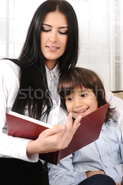 Mother and a son reading a book at home, closeup Stock photo © zurijeta