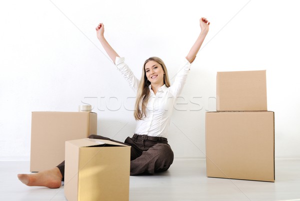 A young teen woman with heands up luggage and belongings moving  Stock photo © zurijeta