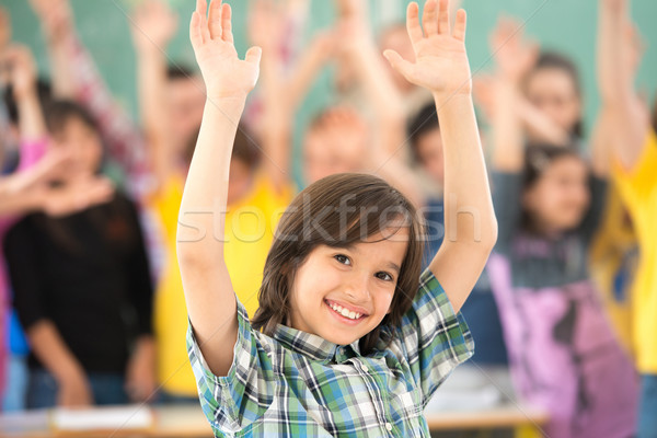 Happy children group with arms outstretched in school classroom Stock photo © zurijeta