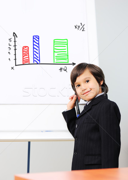 Little kid  drawing a  diagram on a whiteboard, future presentation Stock photo © zurijeta