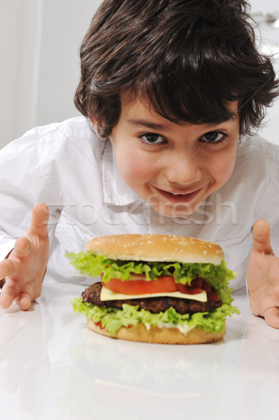 Cute little boy with burger Stock photo © zurijeta