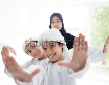 Happy Arabic family having fun time standing in line at home Stock photo © zurijeta