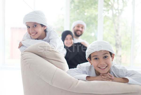 Happy Arabic family having fun at home on sofa Stock photo © zurijeta