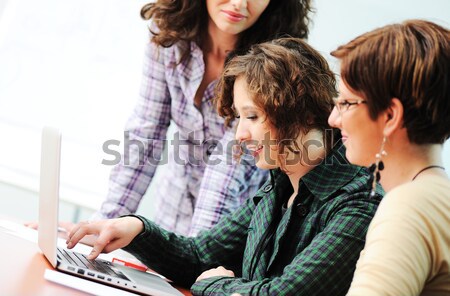 While  meeting, group of young women working together on the table Stock photo © zurijeta