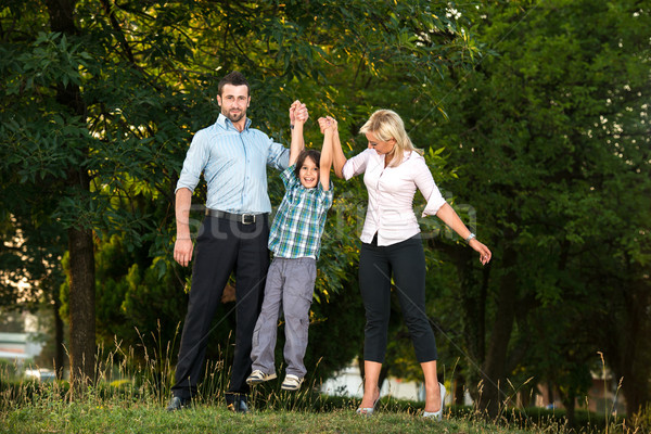 Happy parents lifting their son Stock photo © zurijeta