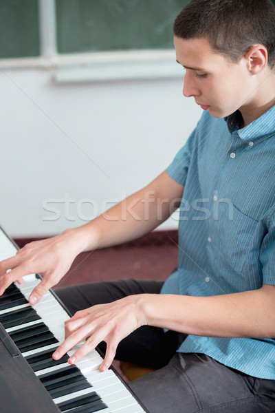 Boy playing piano Stock photo © zurijeta