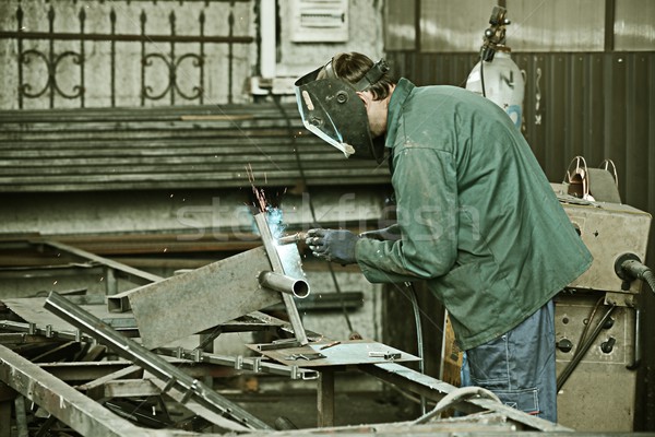 Welder with protective mask welding metal and sparks Stock photo © zurijeta