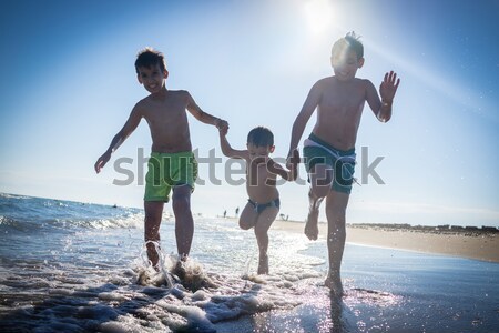 Fun kids playing splash at beach Stock photo © zurijeta