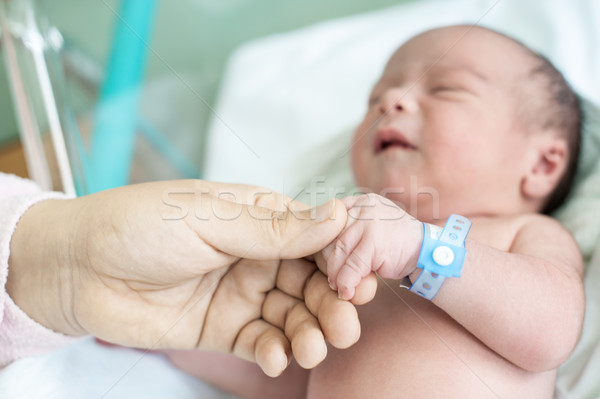 Newborn baby in hospital with id ribbon on his hand Stock photo © zurijeta