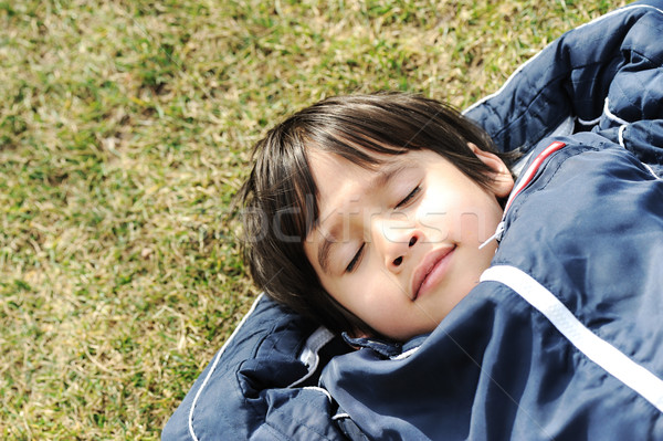 Happy dreaming child on green meadow Stock photo © zurijeta