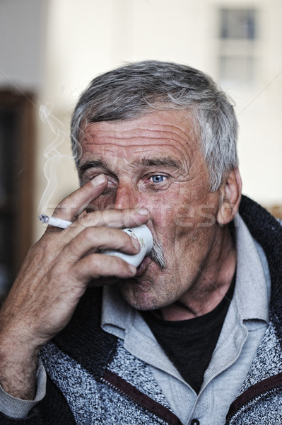 Idős férfi bajusz dohányzás cigaretta iszik kávé Stock fotó © zurijeta