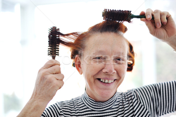 Senior lady hairdressing with many combs Stock photo © zurijeta