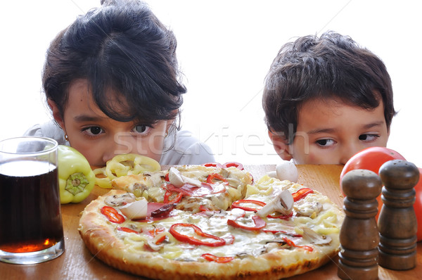 Two children with surprised face on pizza table Stock photo © zurijeta