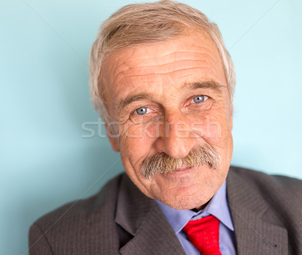 Portrait of a smiling and confident mature businessman with must Stock photo © zurijeta