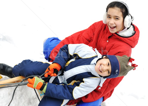Kids sliding sledge in the snow Stock photo © zurijeta