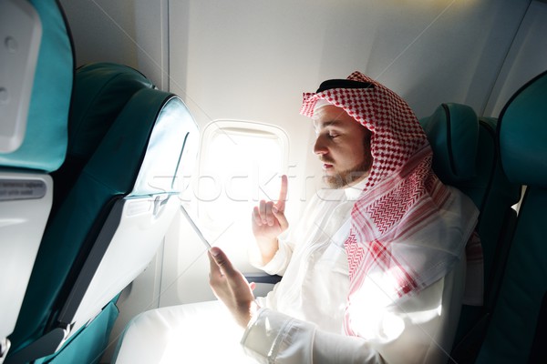 Modern Arabic businessman inside airplane Stock photo © zurijeta