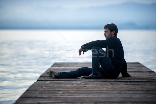 Man sitting on pier Stock photo © zurijeta