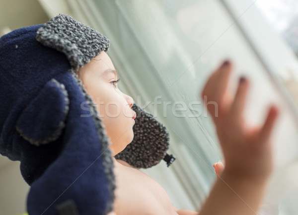 Happy little kid looking trough the window Stock photo © zurijeta