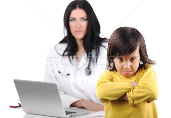 Young female doctor examining little cute angry child refusing examining Stock photo © zurijeta