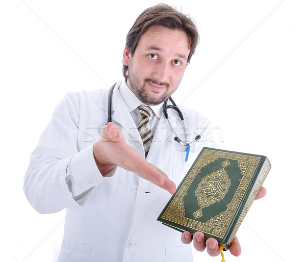 Young attractive muslim male doctor holding Holy book Qoran (no trademark) Stock photo © zurijeta