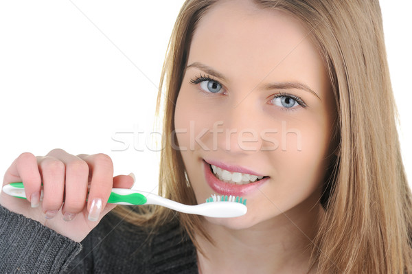 Smiling young woman with healthy teeth holding a tooth-brush Stock photo © zurijeta