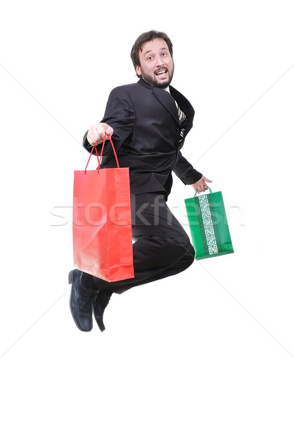 Young attractive businessman jumping with bags in hands Stock photo © zurijeta