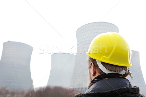 Engineer with protective helmet standing in front of nuclear pow Stock photo © zurijeta