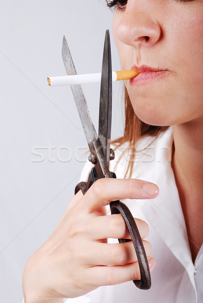 Young woman about to cut off her cigarete Stock photo © zurijeta