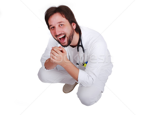 Young male doctor sitting down and laughing Stock photo © zurijeta