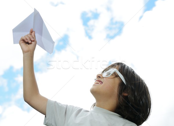 Kid flying a paper airplane Stock photo © zurijeta