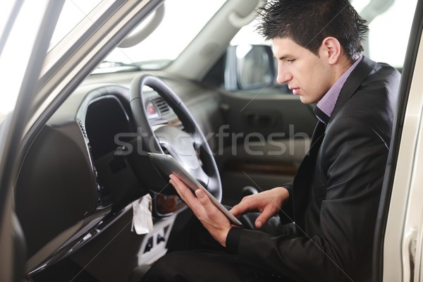 Businessman in the car with the tablet Stock photo © zurijeta