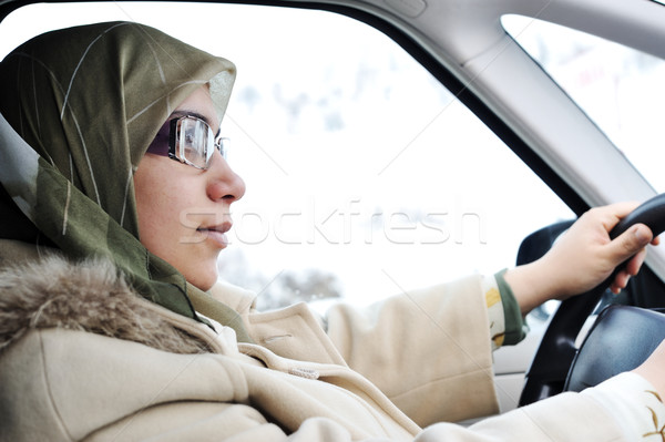 Arabic Muslim woman driving car wearing traditional scarf Stock photo © zurijeta