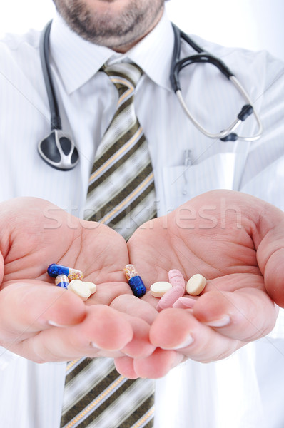 Doctor holiding pills on his palms Stock photo © zurijeta