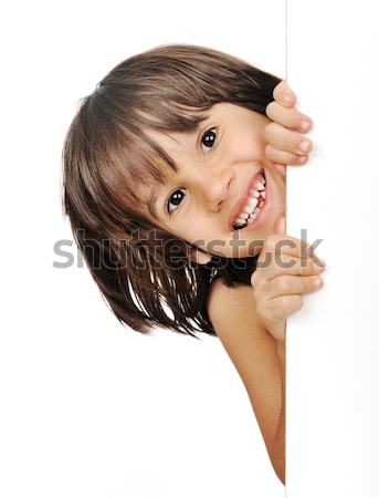 Little boy peeking from behind the advert Stock photo © zurijeta