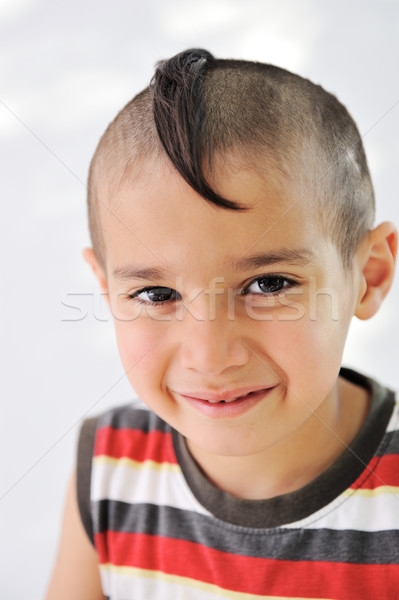 Cute little boy with funny hair and cheerful grimace Stock photo © zurijeta
