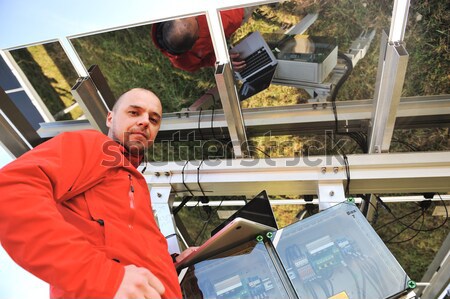 Engineer working with laptop fixing  solar panels Stock photo © zurijeta
