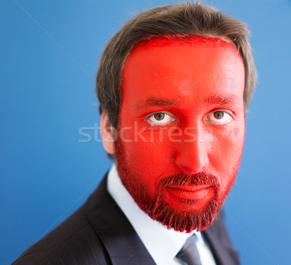Young man portait with red painted face and copy space Stock photo © zurijeta