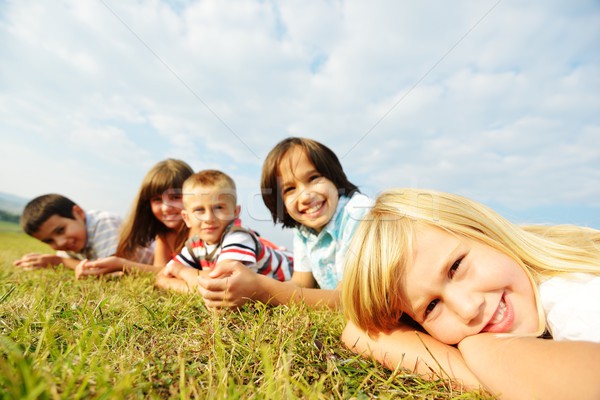 Group of happy children on summer grass meadow in nature Stock photo © zurijeta