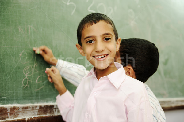 Boys drawing and writing on board in school Stock photo © zurijeta