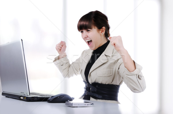 Excited young business woman with her clenched fist Stock photo © zurijeta